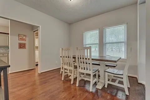 a view of a dining room with furniture and wooden floor