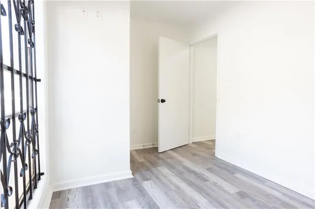 a view of a room with wooden floor