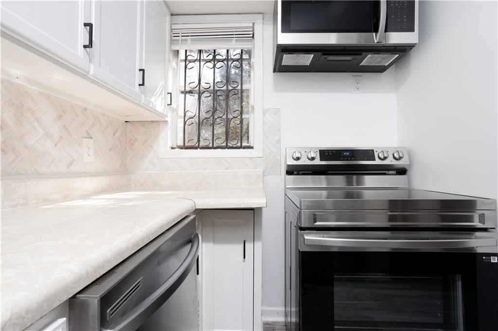 3232 Abbeywood Drive Decatur, GA 30034 - Photo 2 of 17 a kitchen with stainless steel appliances a stove and a microwave