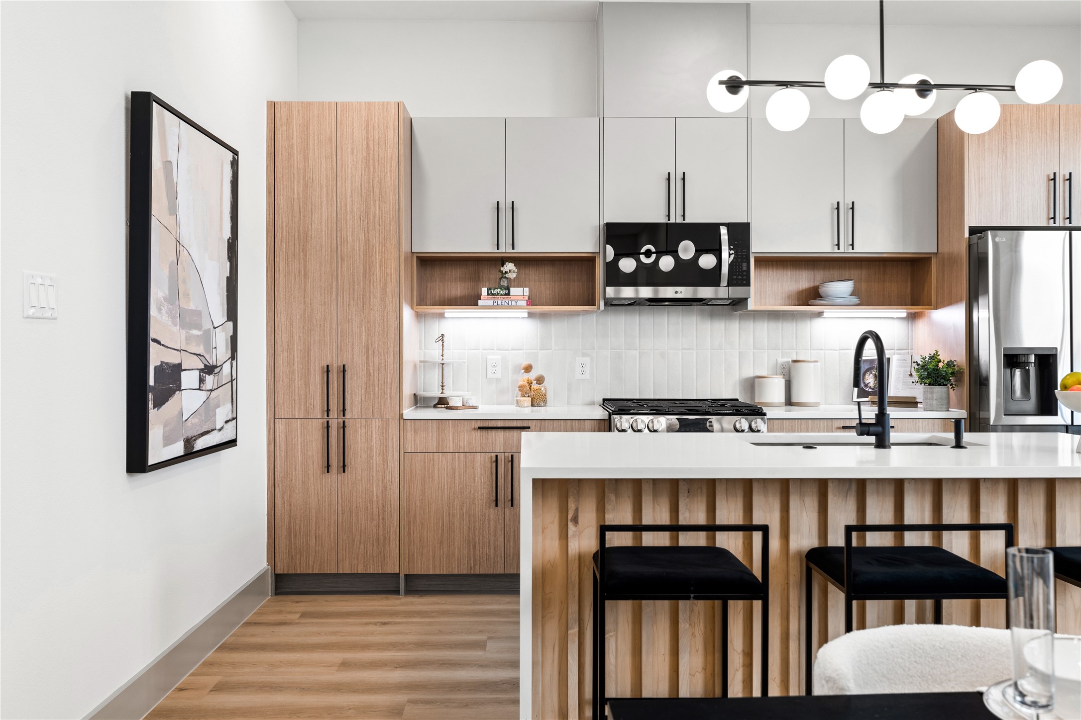 2950 Pitzlin Street Houston, TX 77023 - Photo 10 of 37 Even from the corner, this kitchen tells a story of modern ease—clean lines, natural wood tones, and light-filled windows create a calming atmosphere you’ll love coming home to.