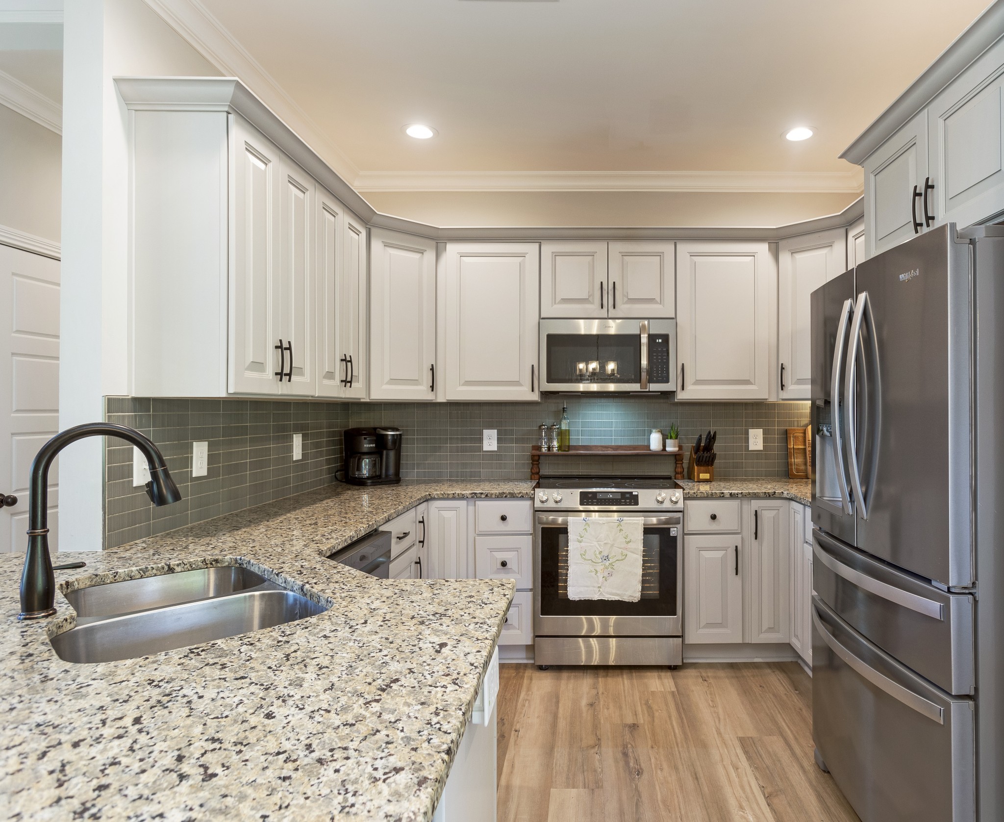 20 Shema Lane Lebanon, TN 37087 - Photo 11 of 38 a kitchen with stainless steel appliances granite countertop a stove a sink dishwasher a refrigerator and a microwave with wooden floor
