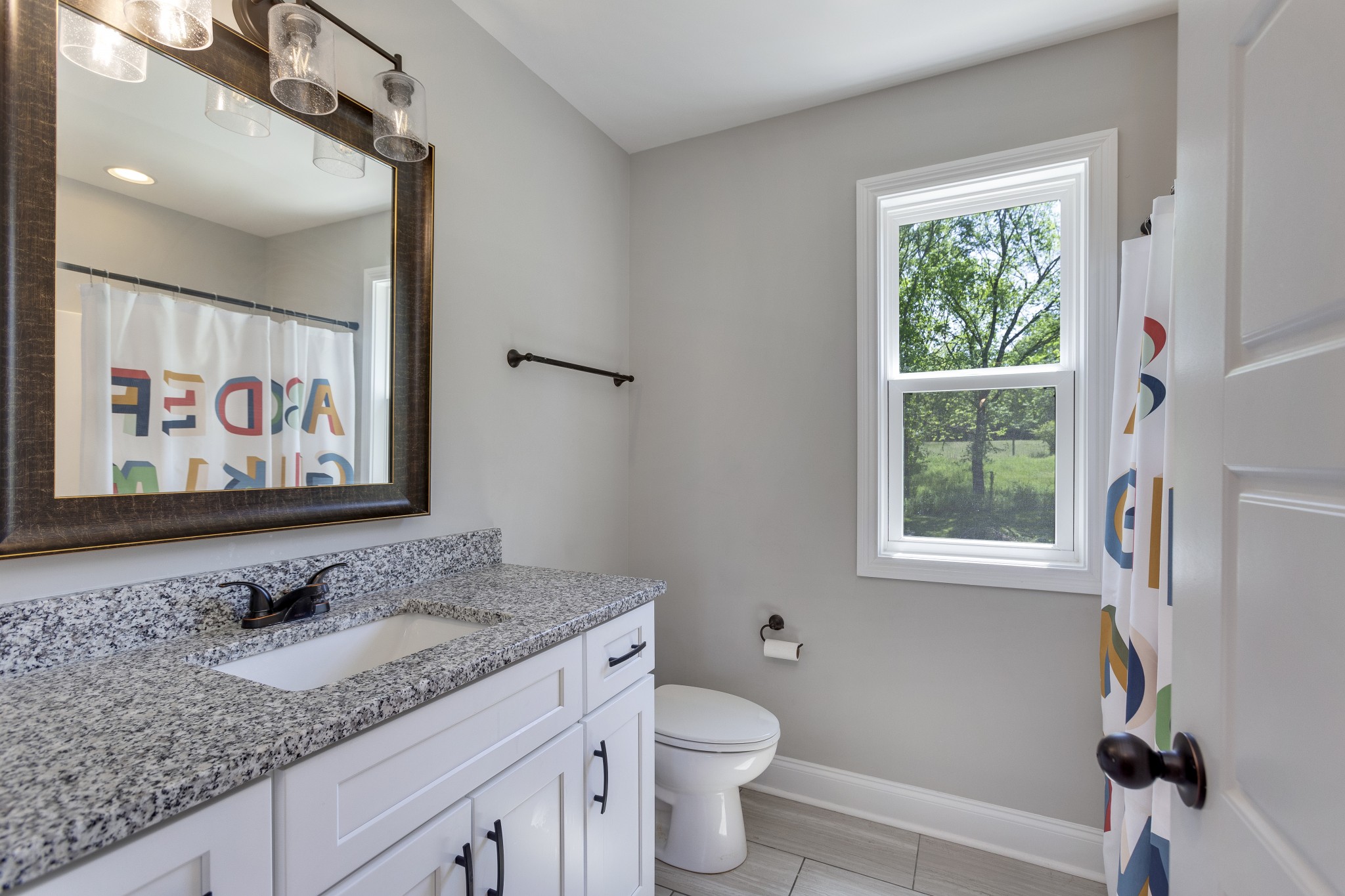 20 Shema Lane Lebanon, TN 37087 - Photo 23 of 38 a bathroom with a granite countertop sink and a mirror