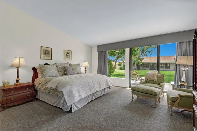 a spacious bedroom with a bed and a large window