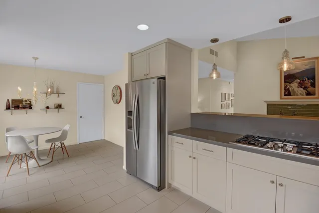 a kitchen with stainless steel appliances a refrigerator and a stove