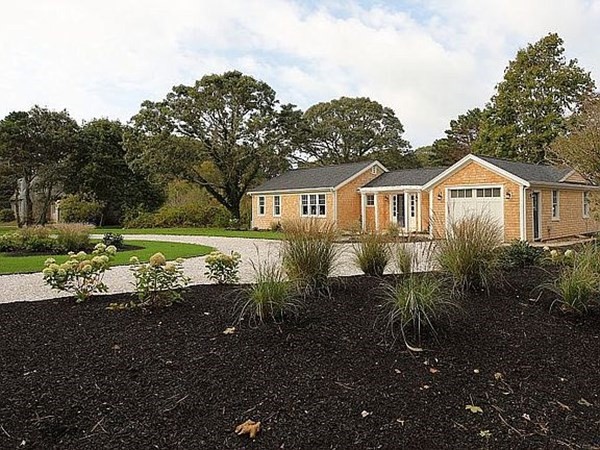 760 Shore Road Bourne, MA 02559 - Photo 3 of 34 a front view of a house with a yard