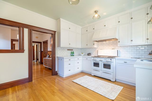 a kitchen with cabinets appliances and a window