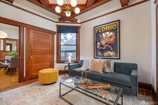a living room with furniture a chandelier and a window