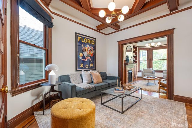 a living room with furniture a flat screen tv and a large window