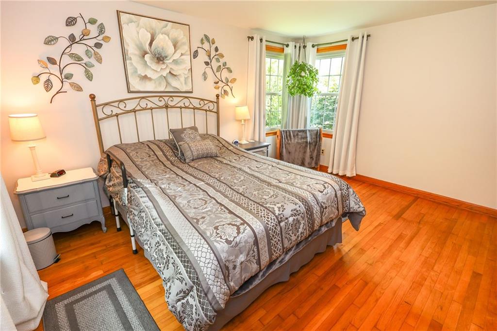 1069 North Keel Ridge Road Hermitage, PA 16148 - Photo 28 of 50 a bedroom with a bed and wooden floor