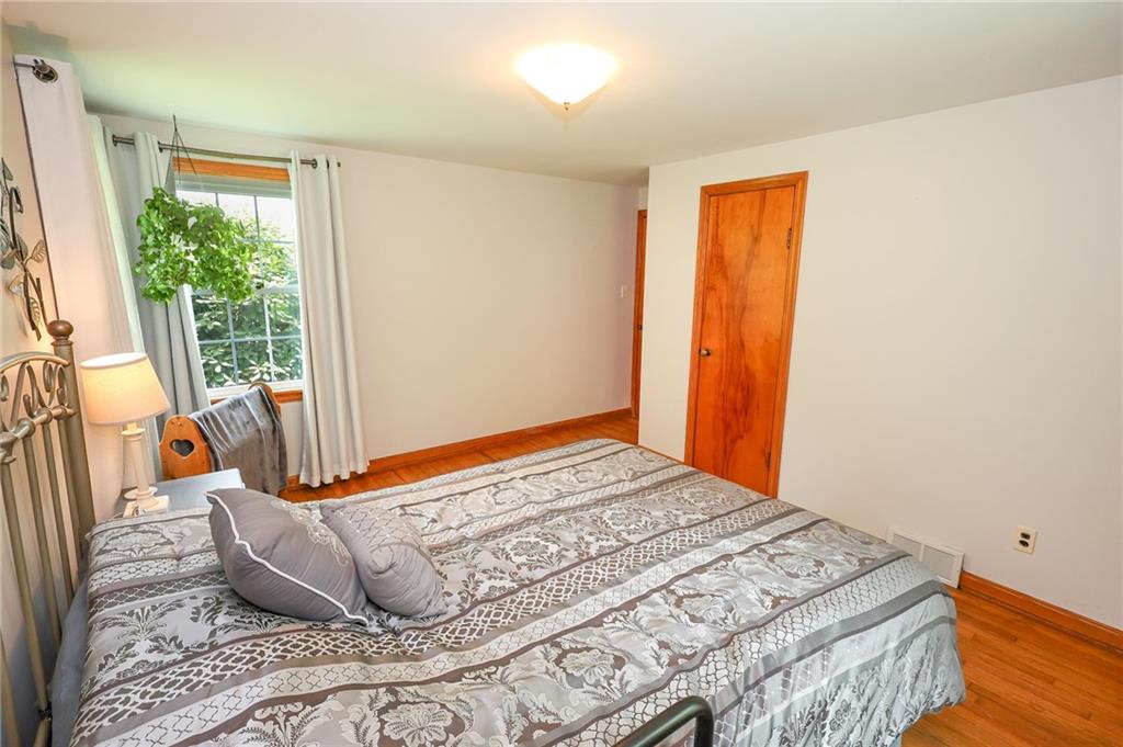 1069 North Keel Ridge Road Hermitage, PA 16148 - Photo 29 of 50 a bedroom with a bed and wooden floor