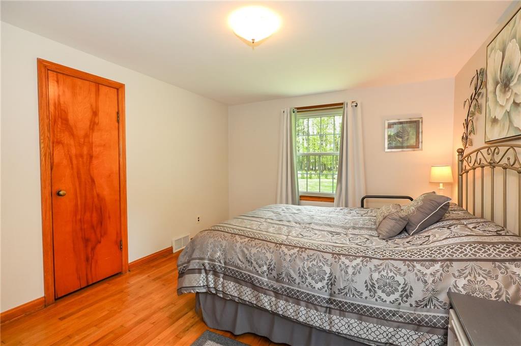 1069 North Keel Ridge Road Hermitage, PA 16148 - Photo 30 of 50 a bedroom with a bed and wooden floor
