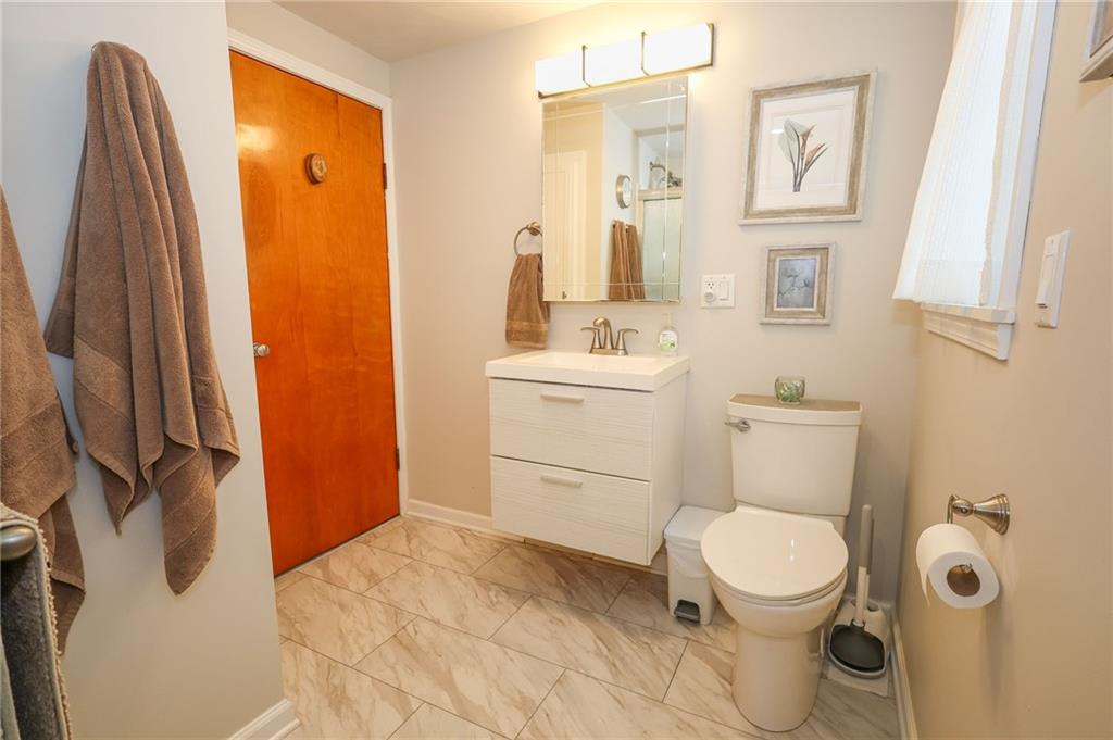 1069 North Keel Ridge Road Hermitage, PA 16148 - Photo 33 of 50 a bathroom with a toilet sink and a mirror