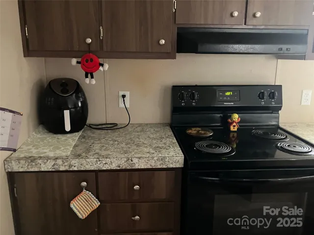 a kitchen with a stove and cabinets
