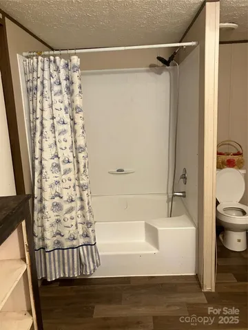 a bathroom with a bathtub and shower