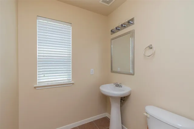 a bathroom with a sink a mirror and a toilet
