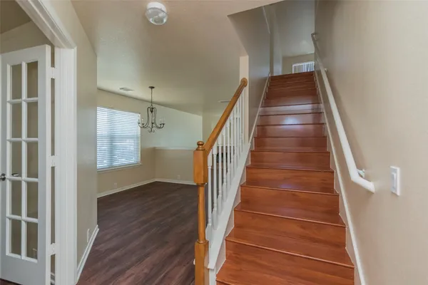 a view of entryway and hall with wooden floor