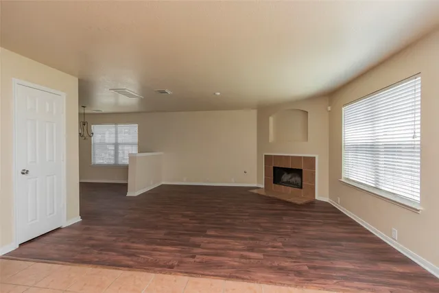 a view of a livingroom with a fireplace and window