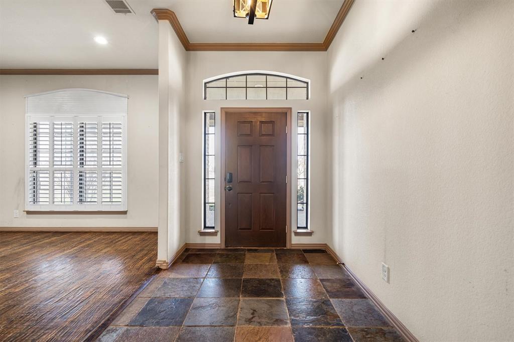 6210 Deer Run Road Sanger, TX 76266 - Photo 12 of 40 an empty room with wooden floor and windows