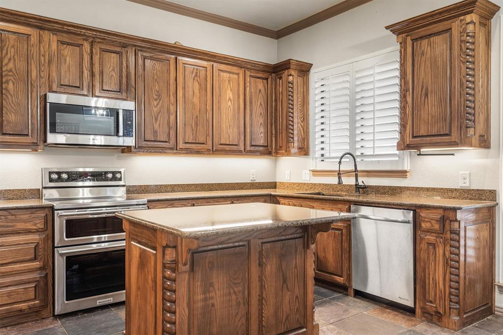 6210 Deer Run Road Sanger, TX 76266 - Photo 16 of 40 a kitchen with a sink stove and microwave