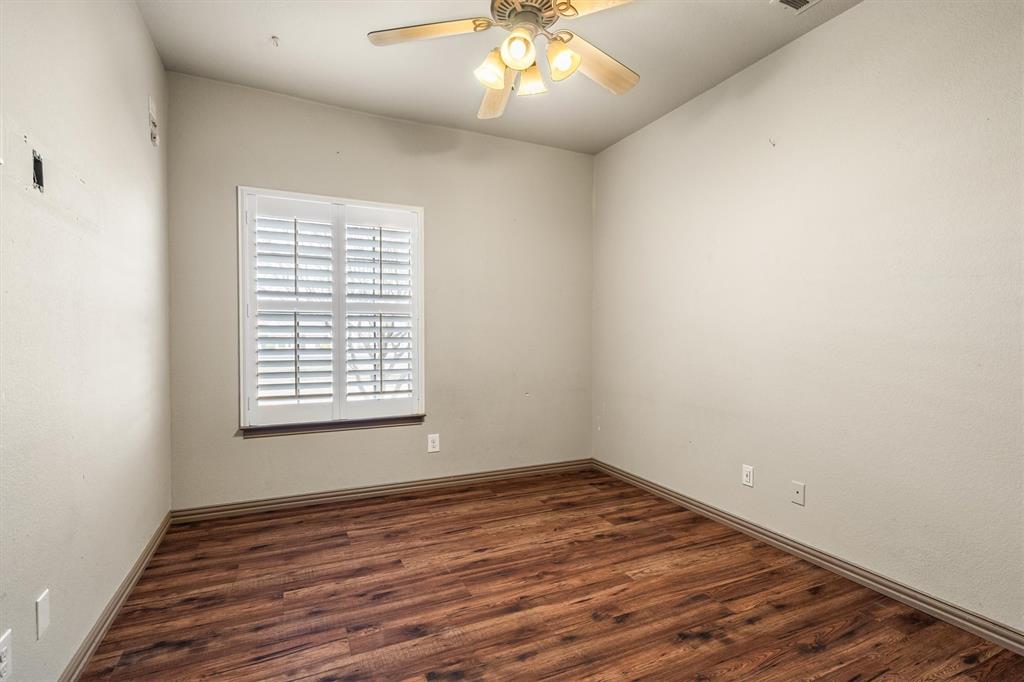 6210 Deer Run Road Sanger, TX 76266 - Photo 25 of 40 an empty room with wooden floor and windows