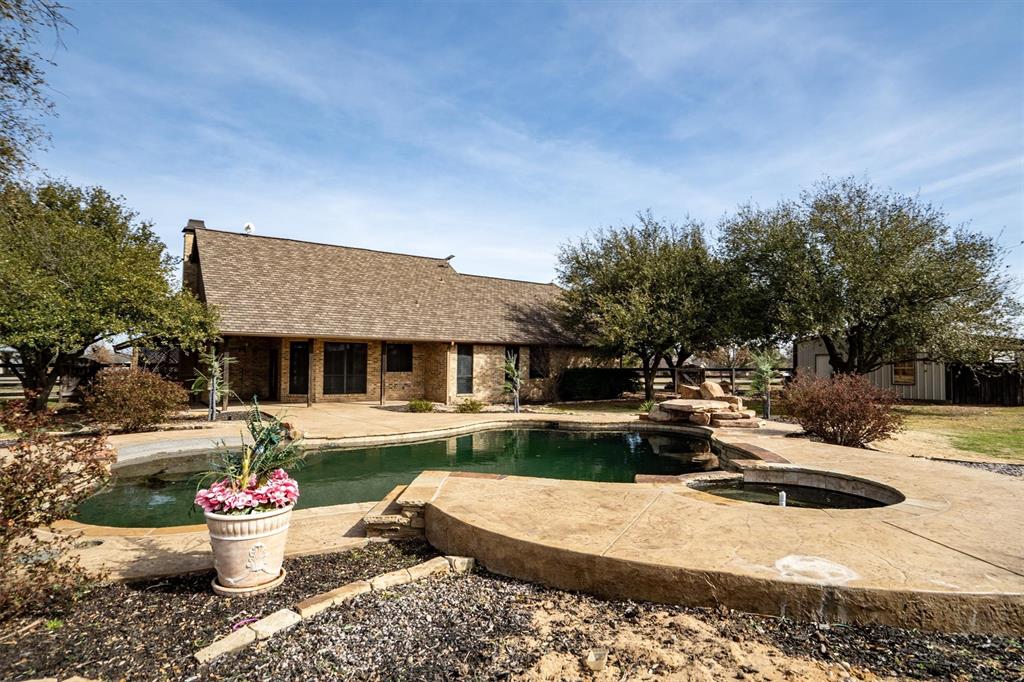 6210 Deer Run Road Sanger, TX 76266 - Photo 28 of 40 a view of a white house with chair and fire pit