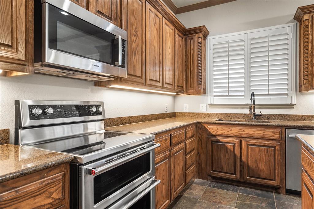 6210 Deer Run Road Sanger, TX 76266 - Photo 3 of 40 a kitchen with a stove microwave and sink