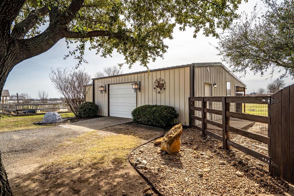 6210 Deer Run Road Sanger, TX 76266 - Photo 35 of 40 a view of a house with wooden fence next to a yard