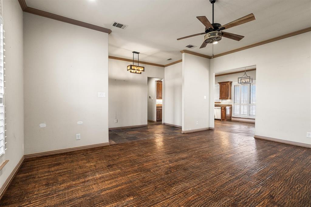 6210 Deer Run Road Sanger, TX 76266 - Photo 4 of 40 a view of a livingroom with wooden floor and a ceiling fan