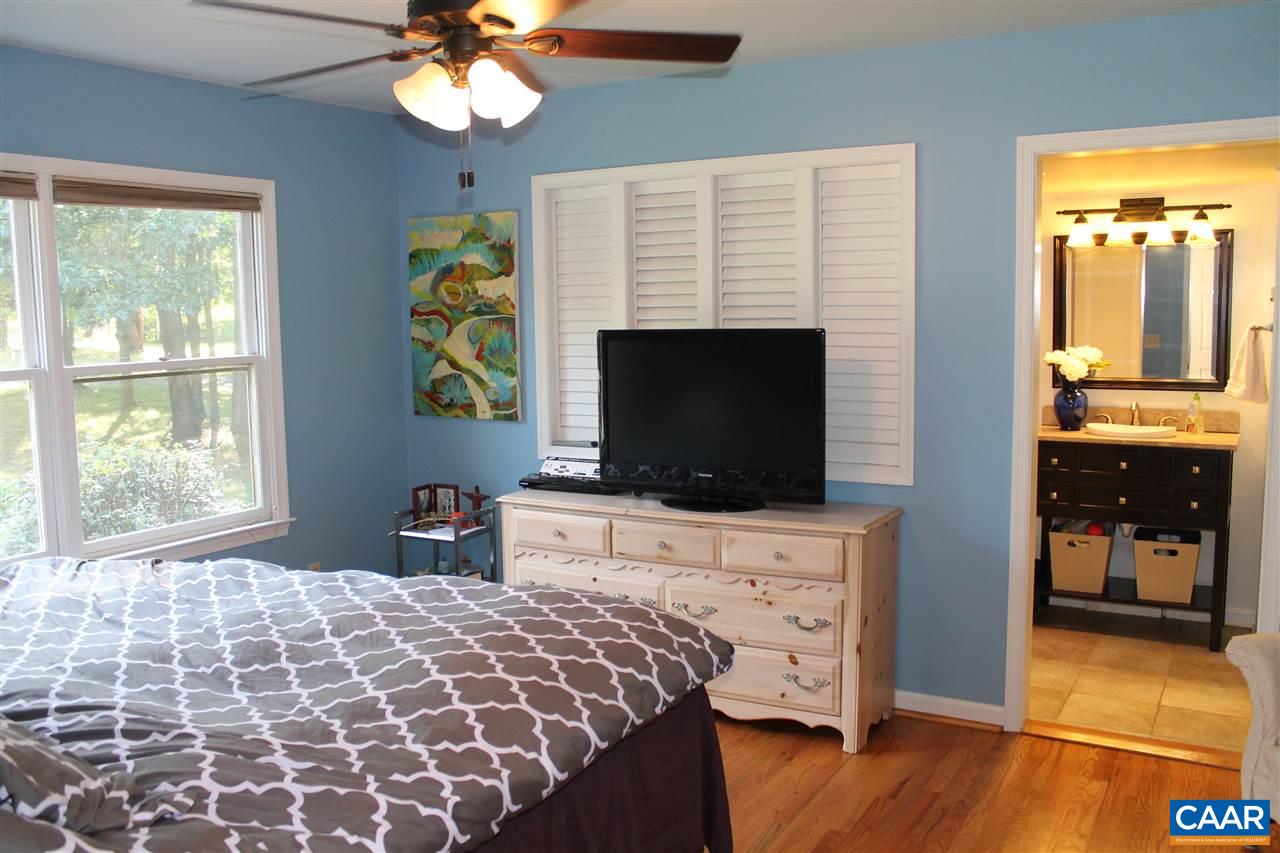 4508 Deer Bonn Road Keswick, VA 22947 - Photo 12 of 28 a bedroom with furniture and a flat screen tv