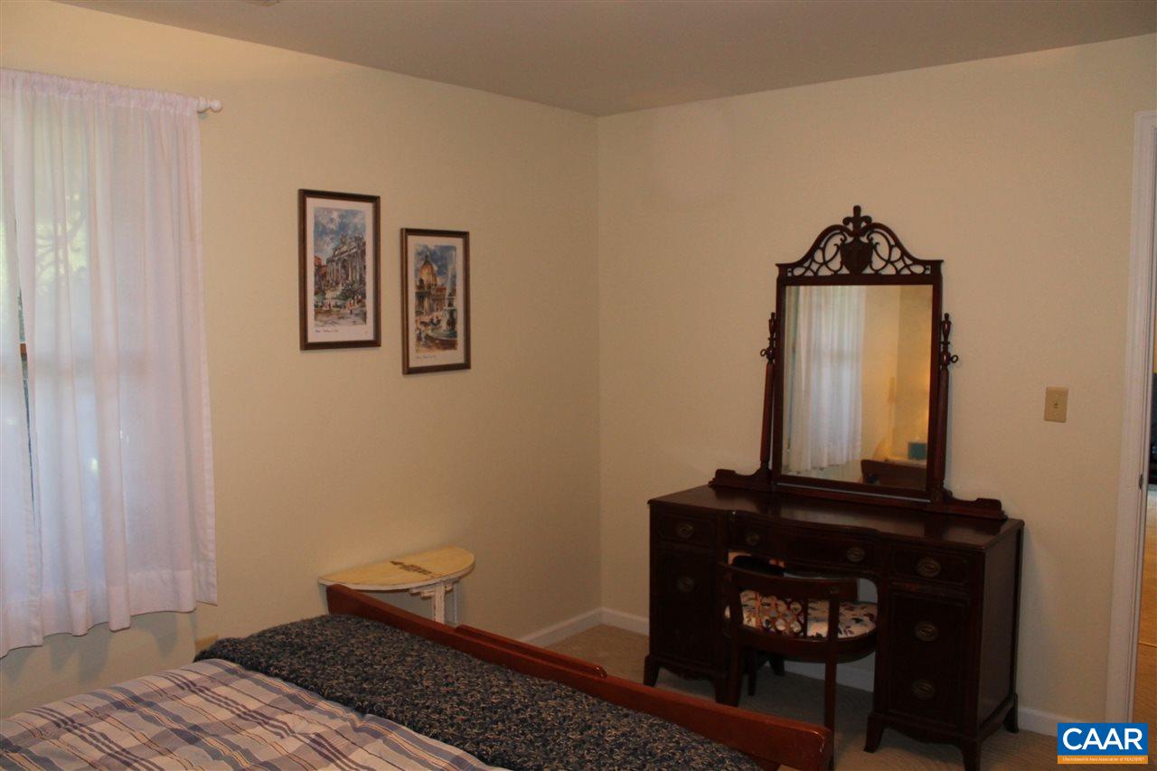 4508 Deer Bonn Road Keswick, VA 22947 - Photo 24 of 28 a view of a hallway with wooden floor and a cabinet