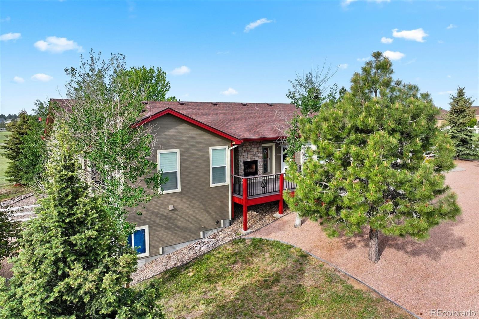 3519 Zane Grey Loop Parker, CO 80138 - Photo 12 of 40 a small garden with a bench in front of the house