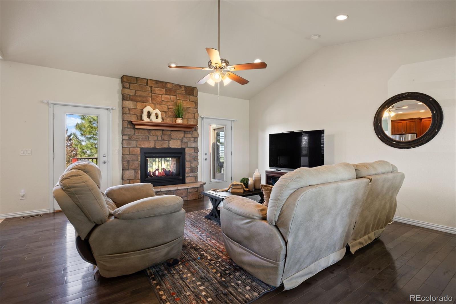3519 Zane Grey Loop Parker, CO 80138 - Photo 13 of 40 a living room with furniture a fireplace and a flat screen tv