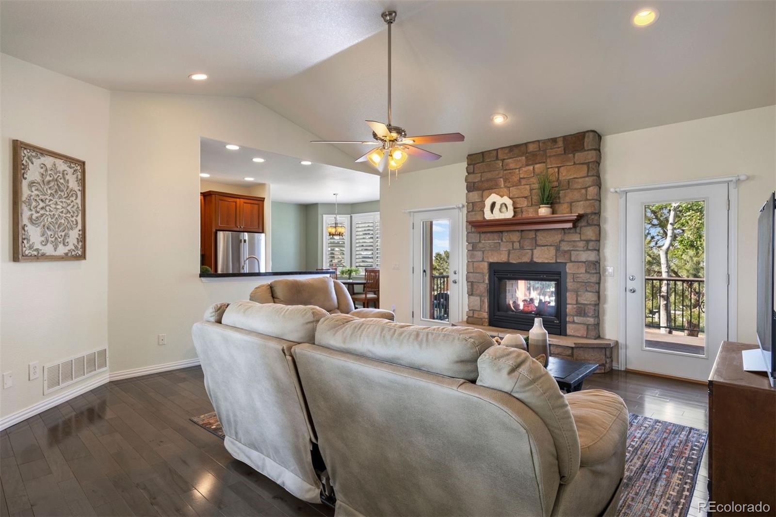3519 Zane Grey Loop Parker, CO 80138 - Photo 14 of 40 a living room with furniture a window and a fireplace