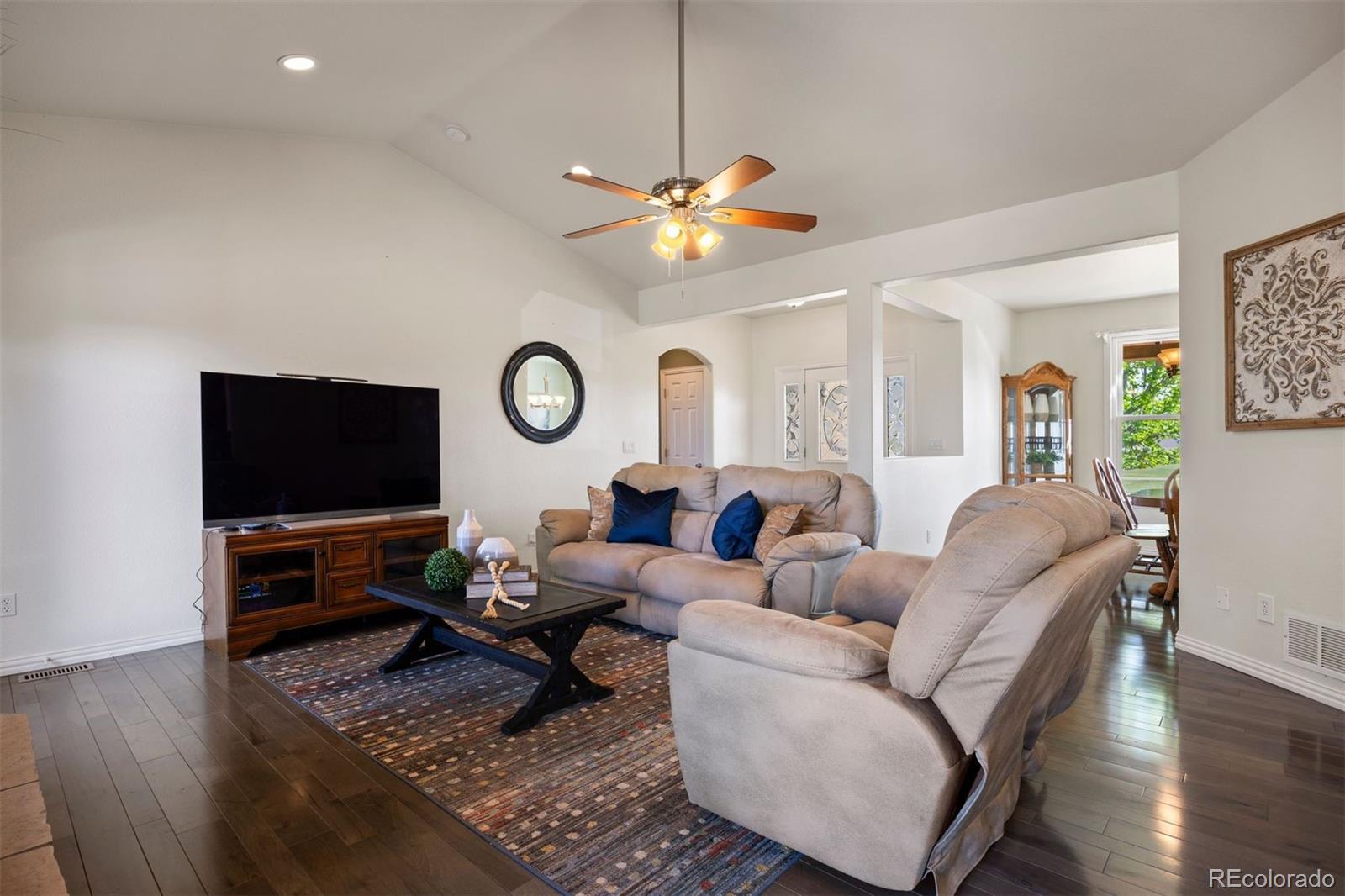 3519 Zane Grey Loop Parker, CO 80138 - Photo 15 of 40 a living room with furniture a flat screen tv and a window