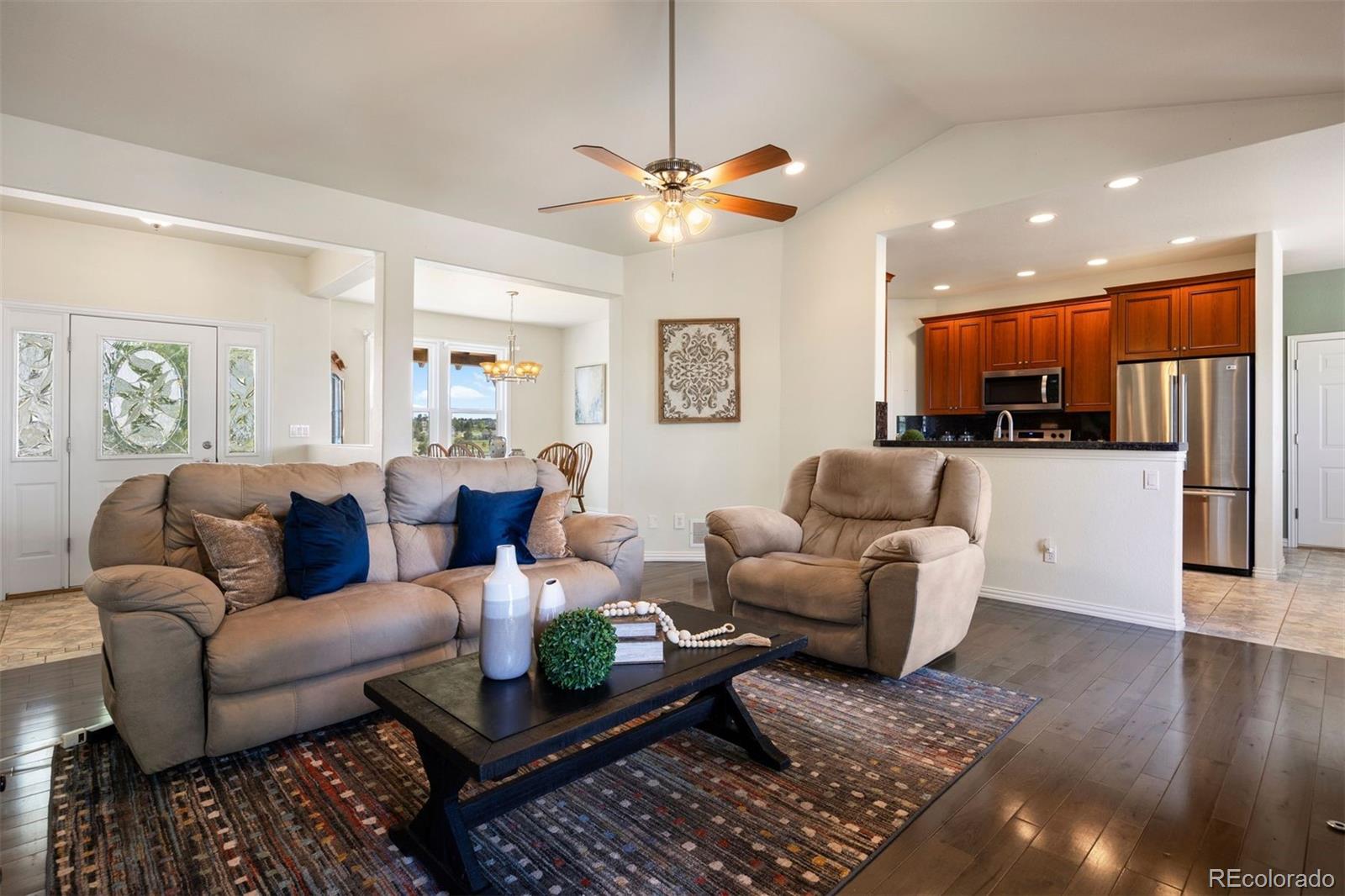 3519 Zane Grey Loop Parker, CO 80138 - Photo 16 of 40 a living room with furniture and kitchen view