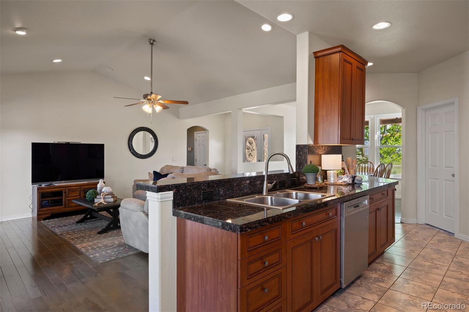 3519 Zane Grey Loop Parker, CO 80138 - Photo 17 of 40 a kitchen with a sink stove and cabinets