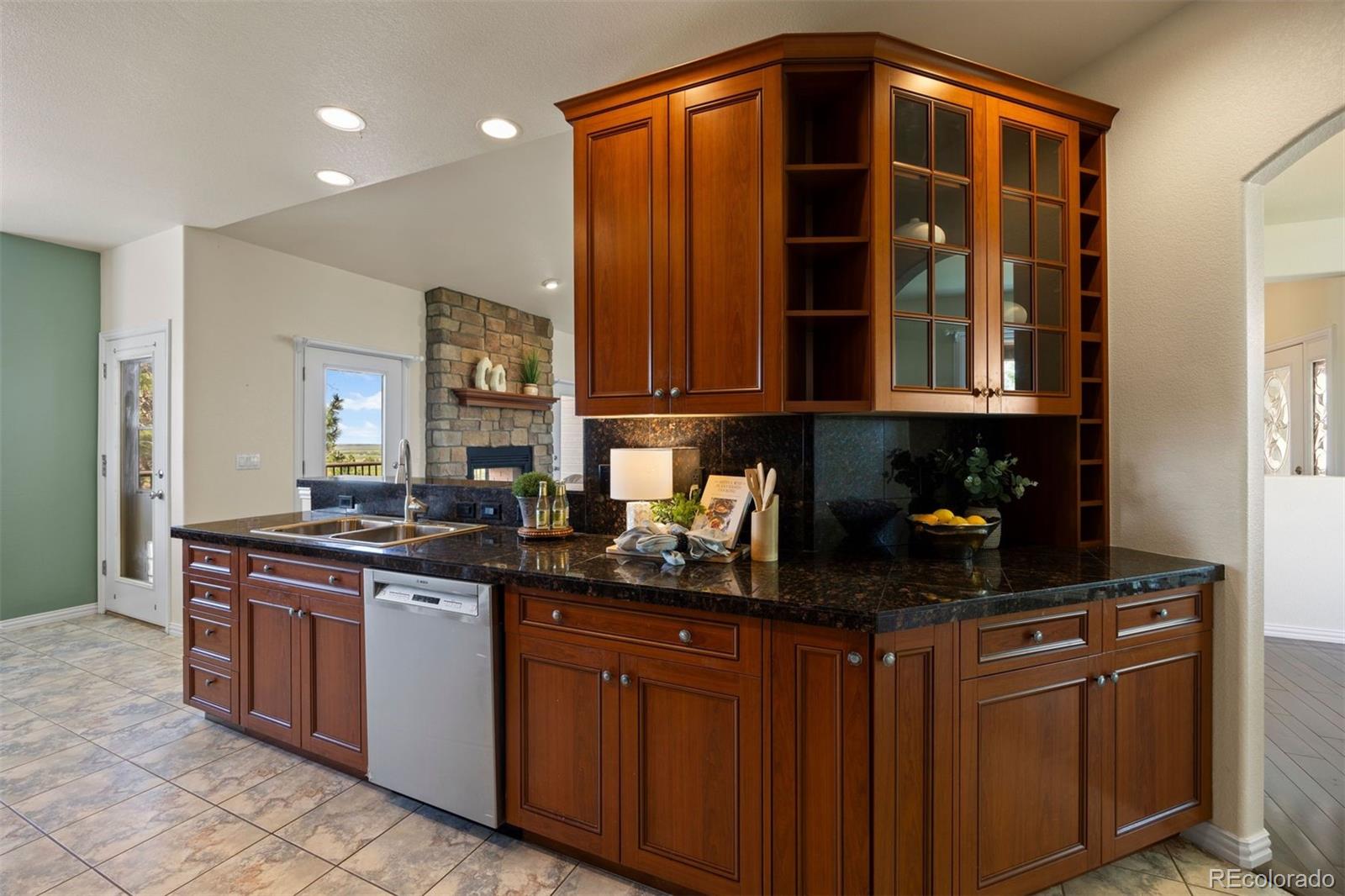 3519 Zane Grey Loop Parker, CO 80138 - Photo 19 of 40 a kitchen with stainless steel appliances granite countertop a sink and cabinets