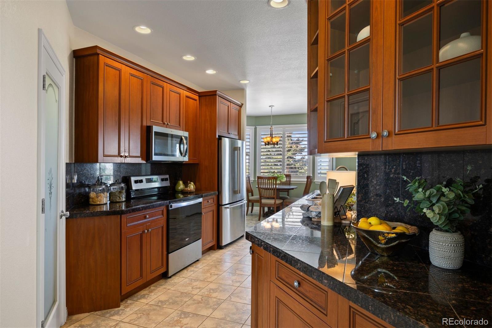 3519 Zane Grey Loop Parker, CO 80138 - Photo 21 of 40 a kitchen with stainless steel appliances granite countertop a stove sink and cabinets
