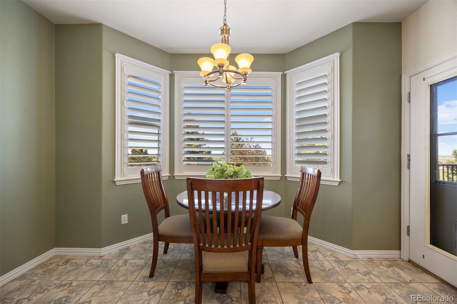 3519 Zane Grey Loop Parker, CO 80138 - Photo 22 of 40 a dining room with furniture and window