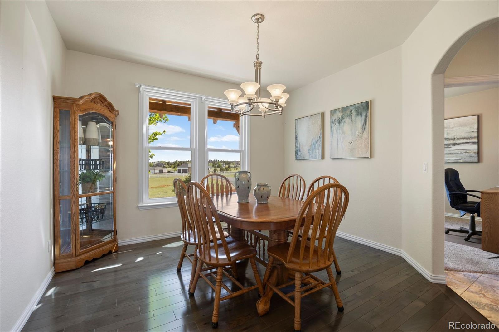 3519 Zane Grey Loop Parker, CO 80138 - Photo 25 of 40 a dining room with furniture a livingroom and chandelier