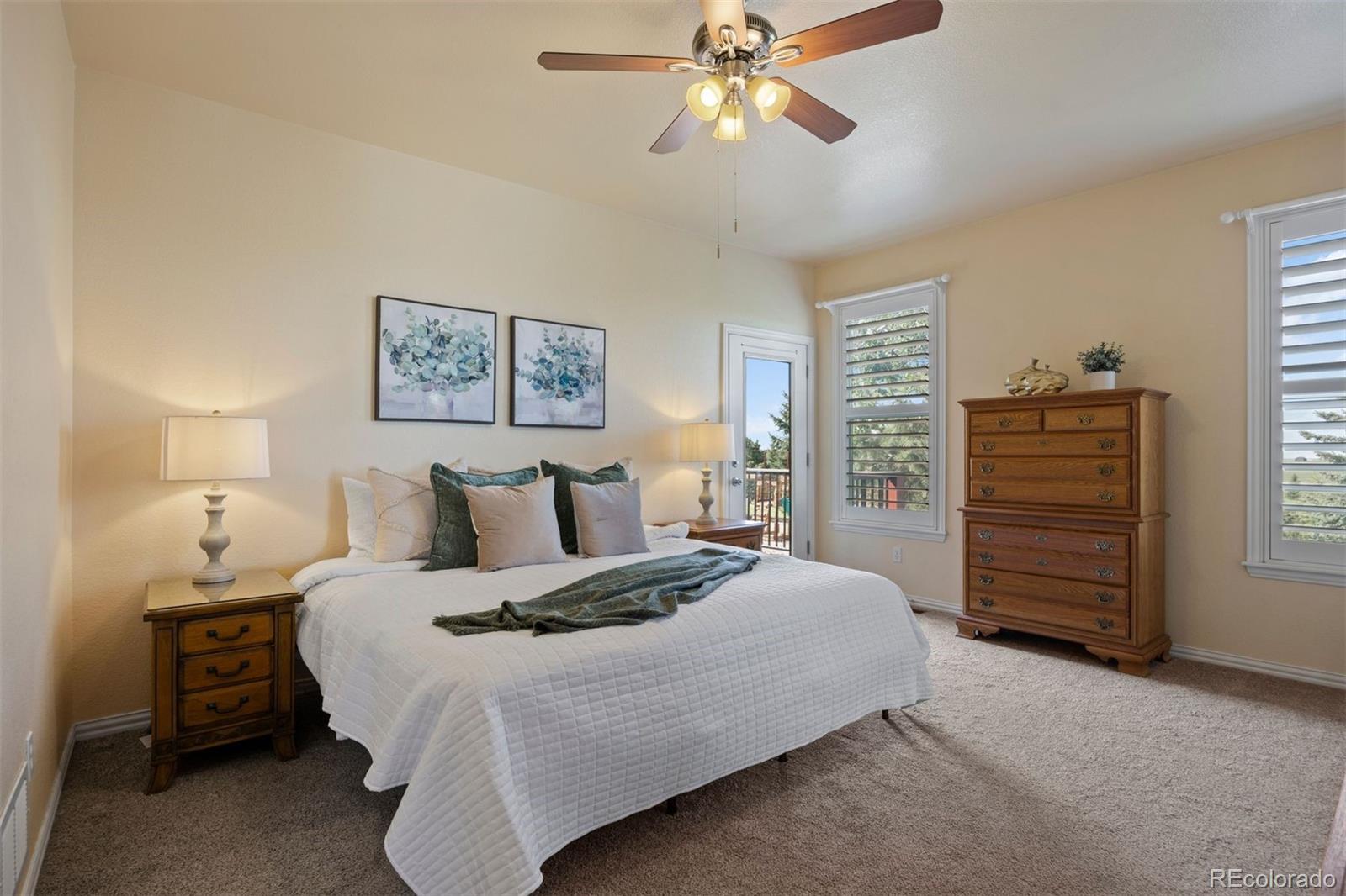 3519 Zane Grey Loop Parker, CO 80138 - Photo 26 of 40 a bedroom with a bed and a chandelier