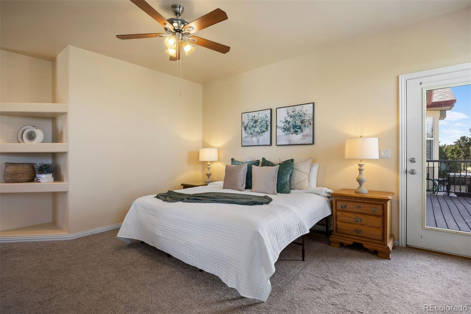 3519 Zane Grey Loop Parker, CO 80138 - Photo 27 of 40 a bedroom with a bed and a lamp on the dresser