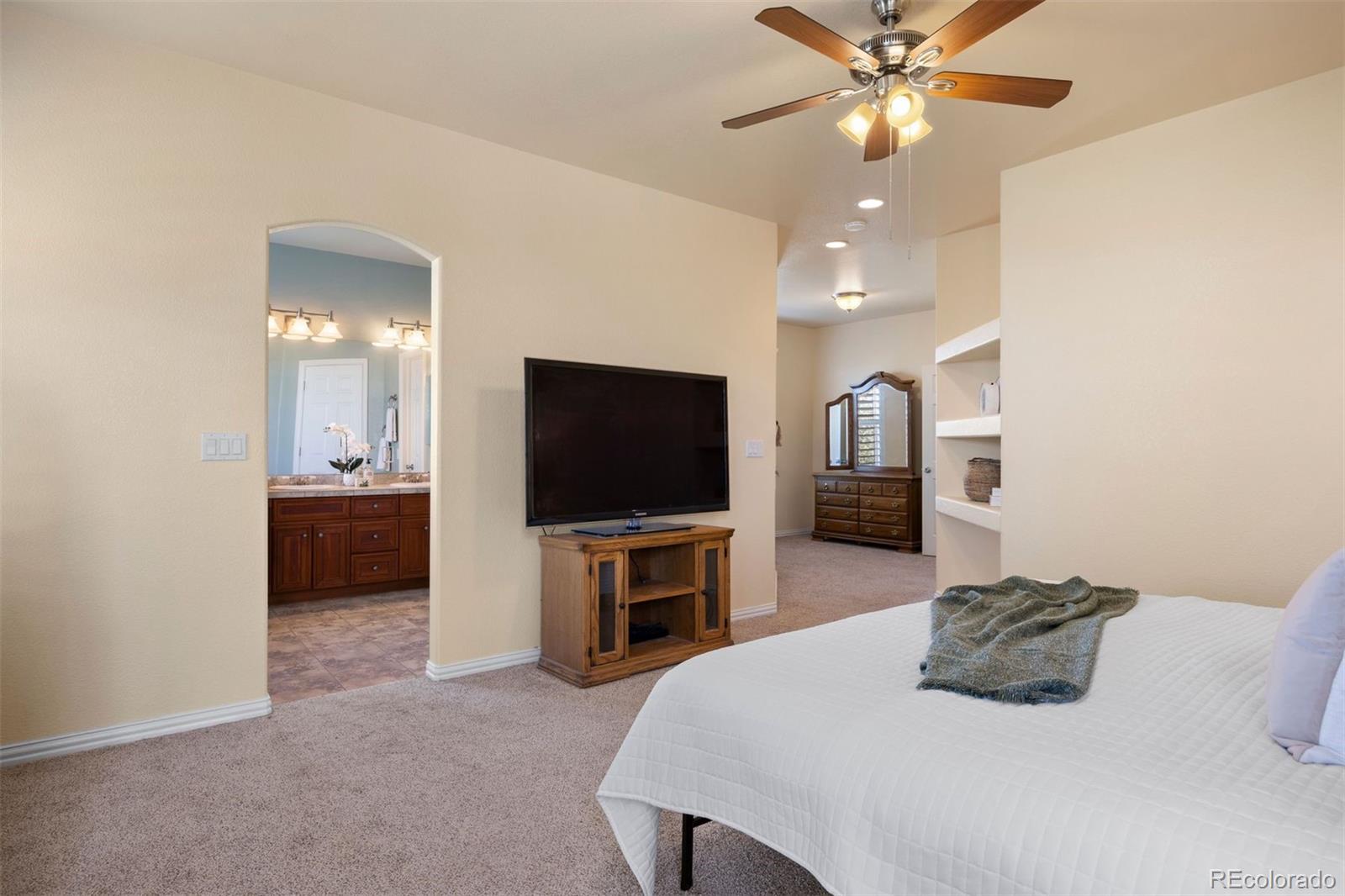 3519 Zane Grey Loop Parker, CO 80138 - Photo 28 of 40 a bedroom with a bed and a television