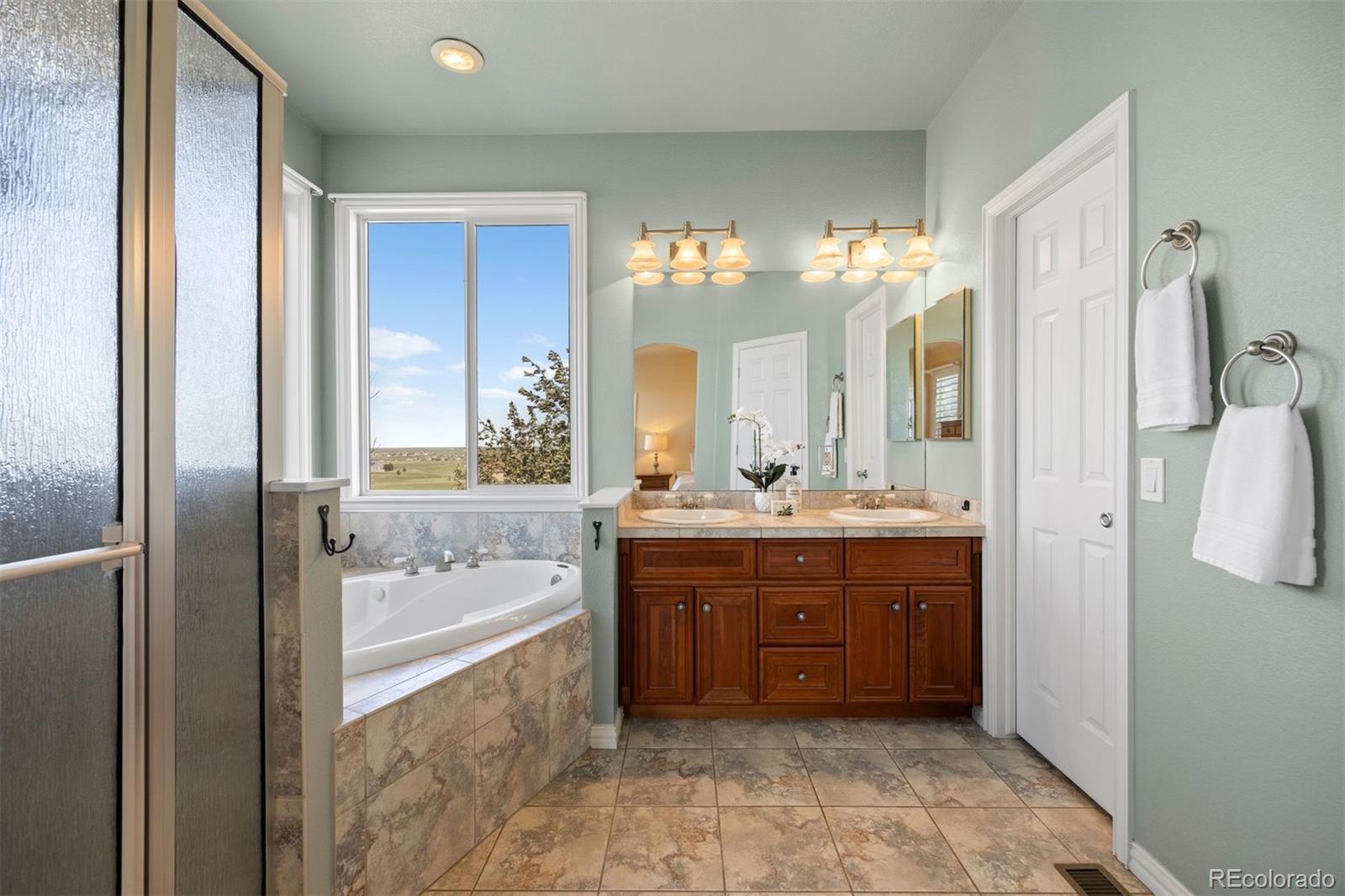 3519 Zane Grey Loop Parker, CO 80138 - Photo 31 of 40 a spacious bathroom with a tub sink and mirror