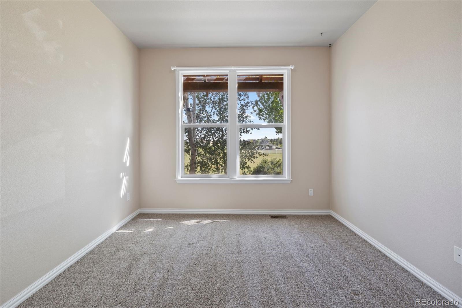 3519 Zane Grey Loop Parker, CO 80138 - Photo 35 of 40 an empty room with a window