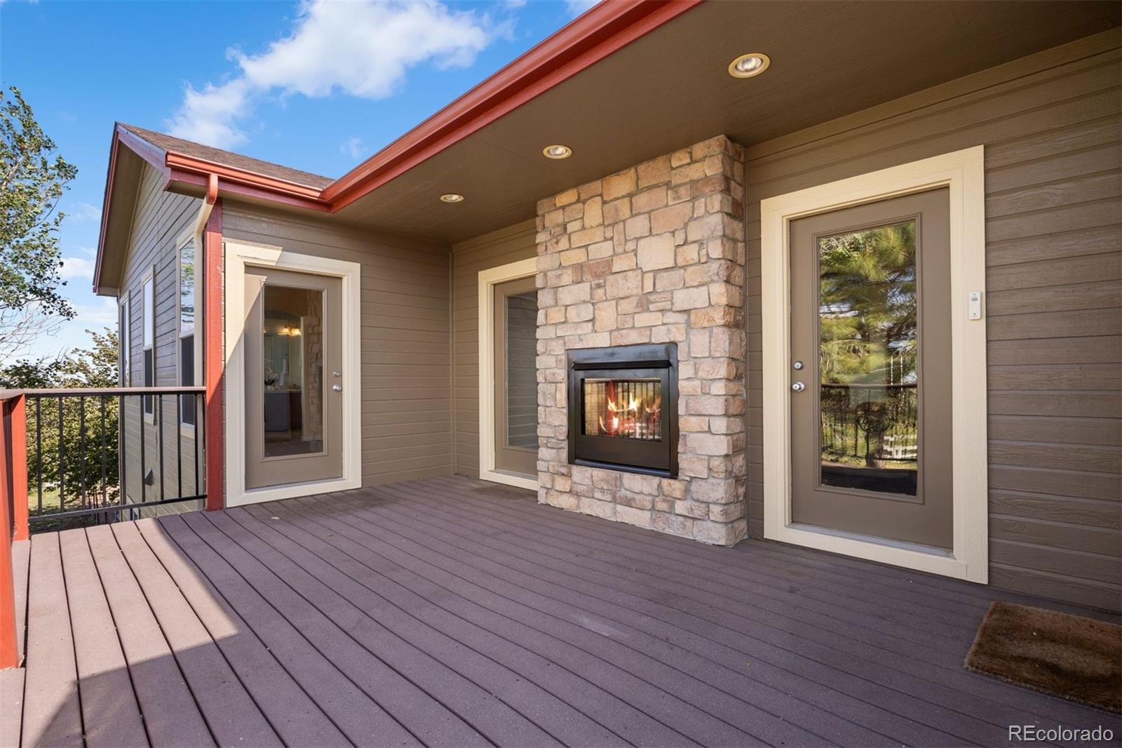 3519 Zane Grey Loop Parker, CO 80138 - Photo 37 of 40 a view of an empty room with wooden floor fireplace and a window