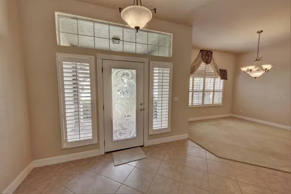 a view of an empty room with window and cabinet