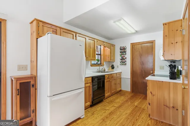a kitchen with stainless steel appliances granite countertop a sink a stove and cabinets