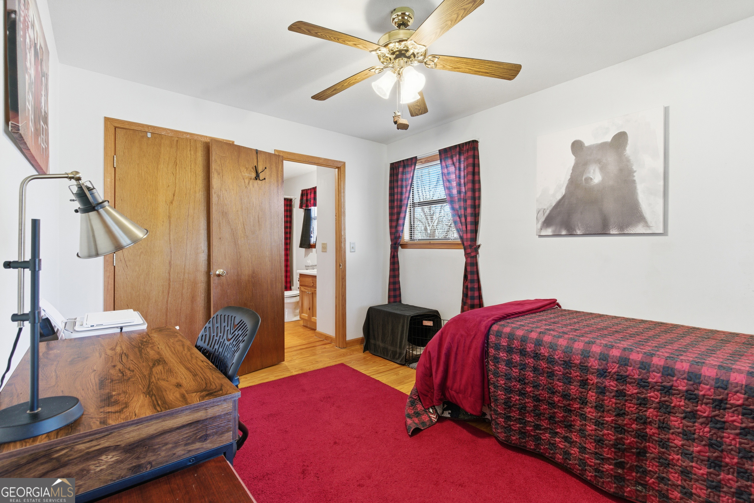 1637 Townsend Mill Road Young Harris, GA 30582 - Photo 19 of 57 a bedroom with a bed and a chandelier