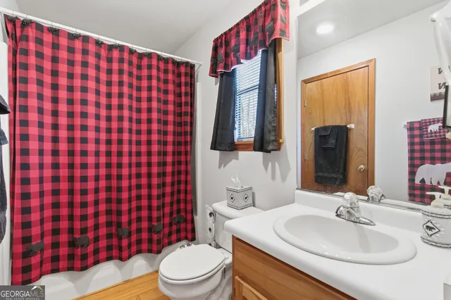 a bedroom with a large bed and a tv